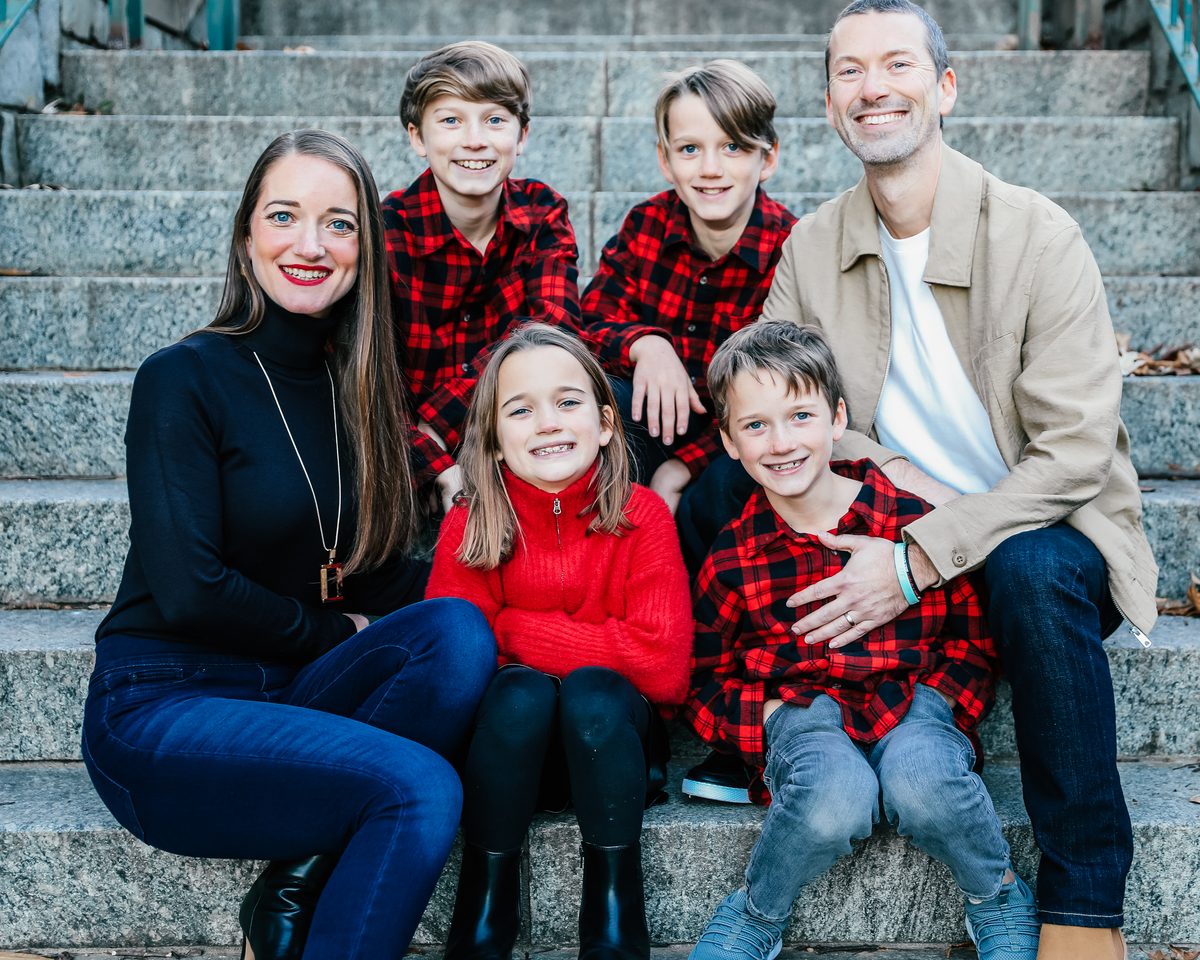 The founders of Cast Your with their four children, sitting together on stone steps